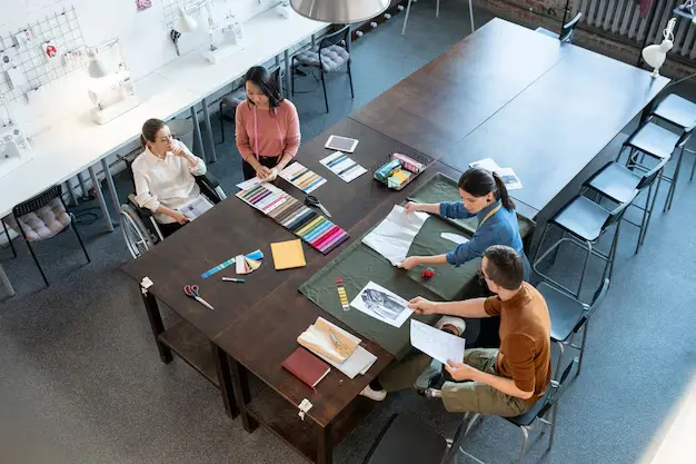 A small group seated around a table during a workshop